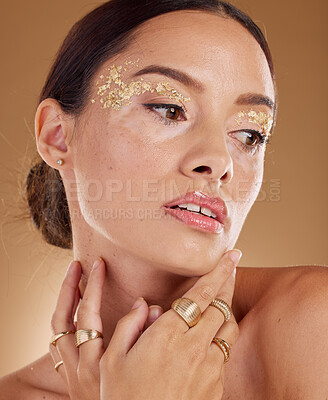 Buy stock photo Face cosmetics, facial glitter and woman with luxury gold eyeshadow, beauty product and skincare glow. Makeup, spa salon or aesthetic model girl with jewelry ring, accessories and healthcare wellness