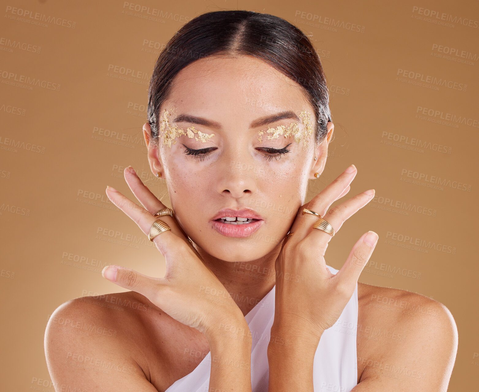 Buy stock photo Gold cosmetics, face glitter and woman with luxury eyeshadow, makeup product and studio skincare glow. Beauty, spa salon and aesthetic model girl with jewelry ring, accessories or vitiligo healthcare
