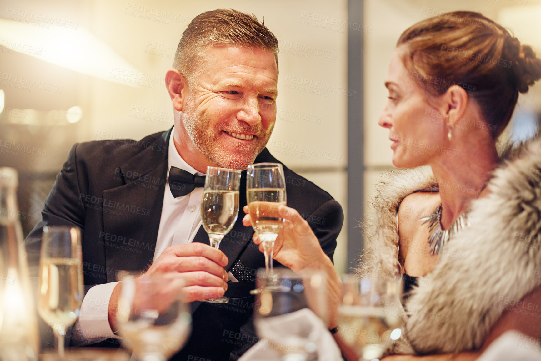 Buy stock photo Success, toast or happy couple in a party in celebration of goals, achievement or new year at luxury event. Motivation, smile or people cheers with champagne drinks or wine glasses at fun dinner gala