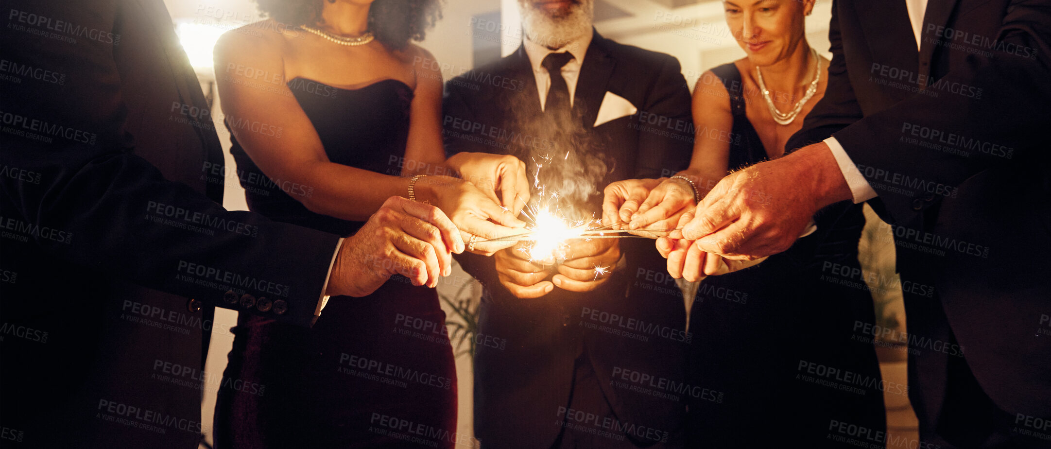 Buy stock photo Fire, sparklers and people at a luxury party, event or celebration for new year with formal outfit. Celebrate, matches and group of friends in classy clothes at a black tie gala, banquet or dinner.