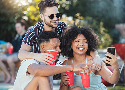 Buy stock photo Friends, selfie and party outdoor, drinks and playful in summer, bonding together and celebration. Young people, men and black woman with smartphone, share picture or event outside, alcohol and smile