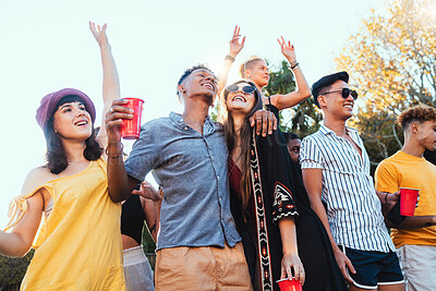 Buy stock photo Drinks, party and a couple of friends dancing outdoor to celebrate at festival, concert or social event. Diversity young men and women people together while happy, singing and drinking alcohol