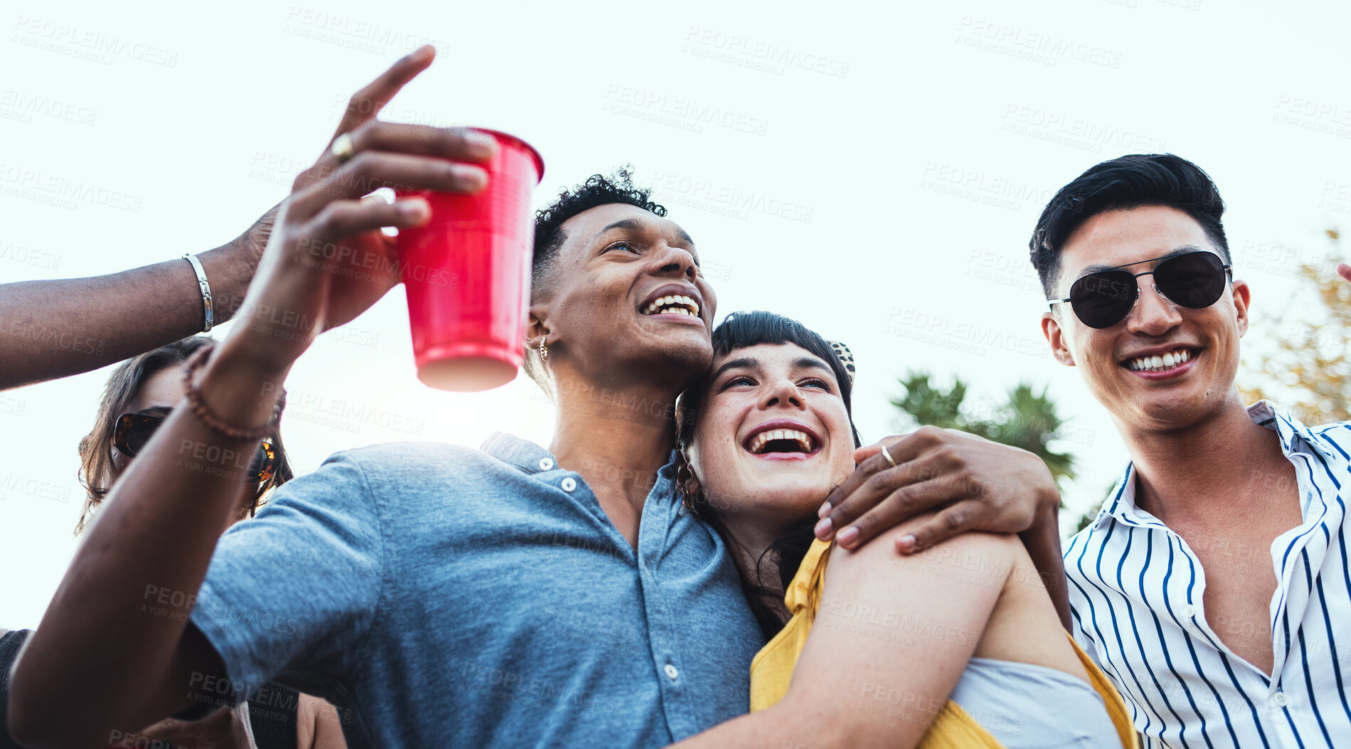 Buy stock photo Couple of friends, party and drinks outdoor to celebrate at  festival, concert or social event. Diversity young men and women people together while dancing, happy and drinking alcohol in crowd