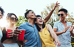 Drinks, party and a couple of friends dancing outdoor to celebrate at festival, concert or social event. Diversity young men and women people together in summer, happy and drinking alcohol in crowd