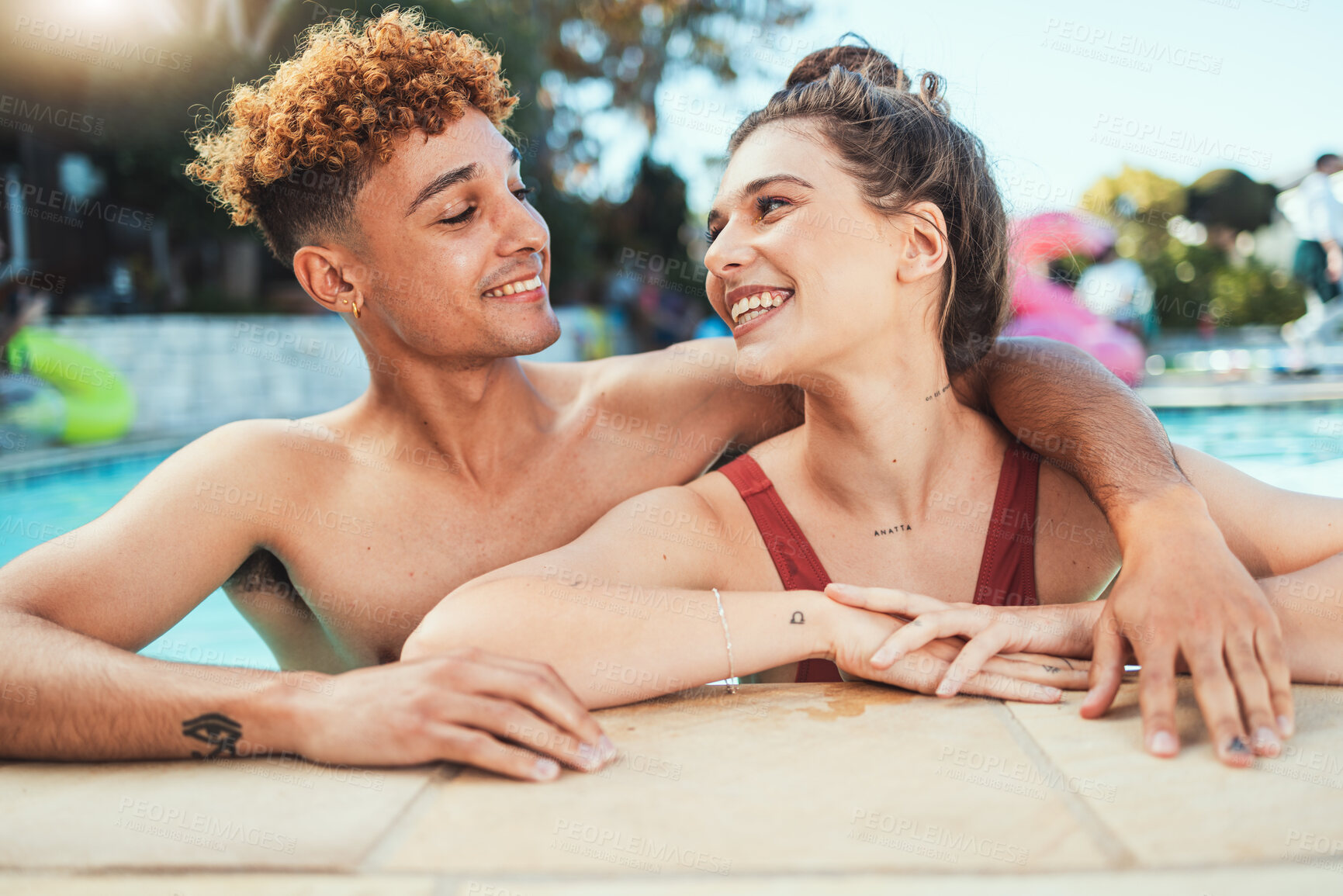Buy stock photo Party, swimming and diversity with a couple of friends in the pool outdoor together during summer. Love, water and swim with a young man and woman swimmer enjoying a birthday or celebration event