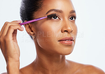 Buy stock photo Eyelash, brush and makeup of black woman in studio for cosmetics, skincare and transformation. Face, beauty and mascara application for lashes, facial tool and eyes of model for beautiful aesthetic
