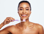Portrait, dental and a black woman brushing teeth in studio isolated on a white background for oral hygiene. Face, toothbrush and toothpaste with an attractive young female posing on blank space