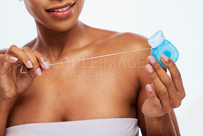 Buy stock photo Dental, floss in hands and black woman, flossing for teeth whitening, health and hygiene isolated on white background. Oral care product, skincare and mouth cleaning for fresh breath in studio