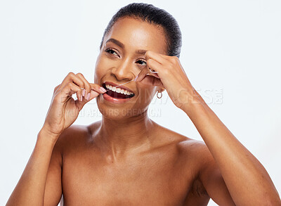 Buy stock photo Dental hygiene, floss and black woman cleaning mouth, wellness and studio background. African American female, lady and oral health with string for teeth, remove plaque from tooth enamel and cavities
