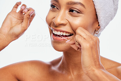 Buy stock photo Face, hands and black woman flossing teeth, dental health and hygiene isolated on white background. Oral care product, floss and mouth cleaning for fresh breath in studio with happy model