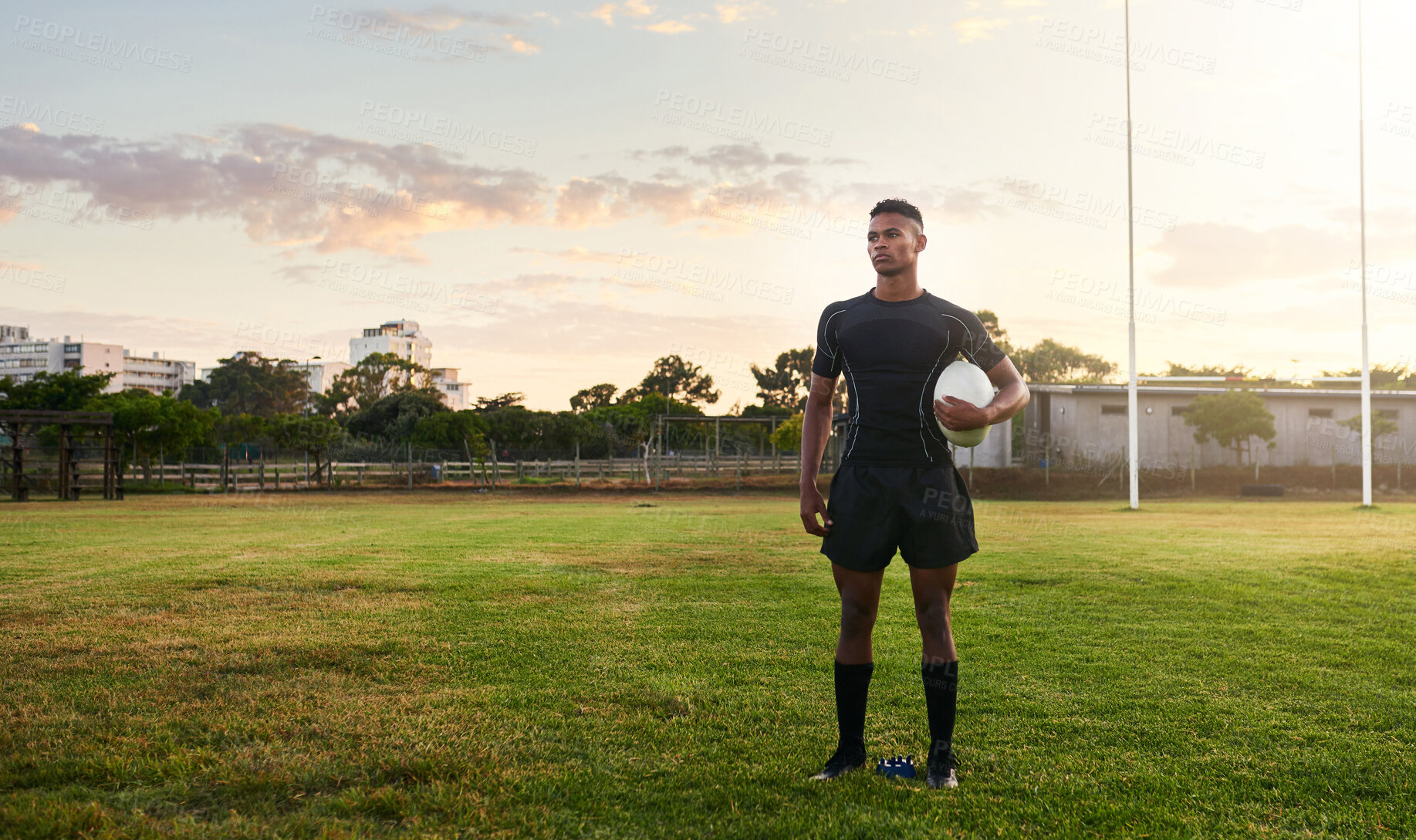 Buy stock photo Rugby player, sports and standing on field with ball ready for game, match or practice outdoors. Sporty man athlete or professional waiting for rugby competition, training or play time on green grass