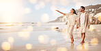 Love, romance and a couple walking on the beach while holding hands with mockup while on vacation for travel. Nature, summer and honeymoon with a man and woman taking a walk on the sand by the sea