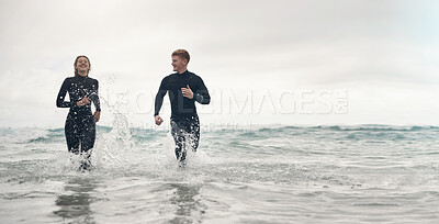 Running, surfing and mockup with a sports couple in the ocean or sea for leisure or recreation. Beach, fitness and mock up with a man and woman training together in the water during summer