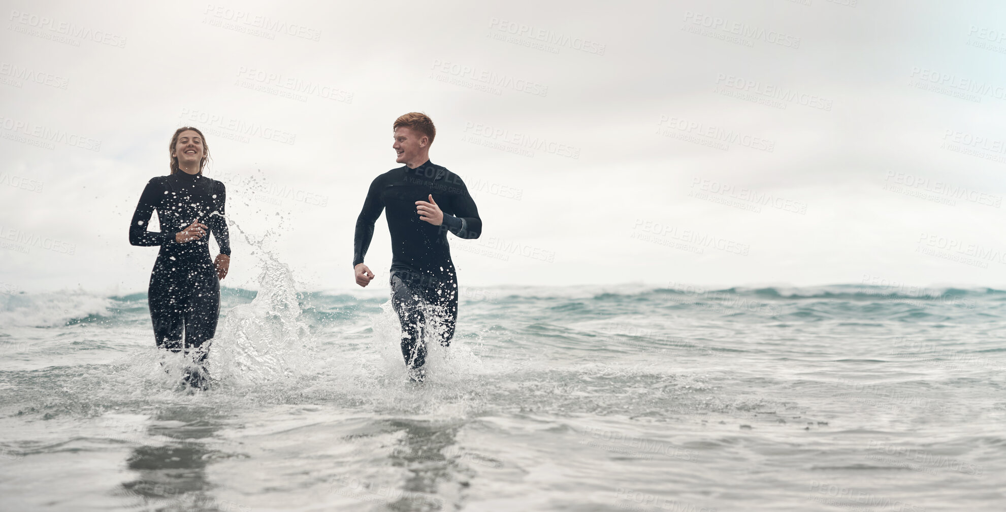 Buy stock photo Running, surfing and mockup with a sports couple in the ocean or sea for leisure or recreation. Beach, fitness and mock up with a man and woman training together in the water during summer