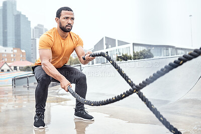 Buy stock photo Outdoor, exercise and man with ropes, workout or training for wellness, fitness or healthy lifestyle. Outside, male or athlete swinging battle ropes, body care or intense movement for energy or power