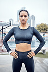 Black woman, portrait and fitness with arms akimbo in city for exercise, wellness and training in Atlanta. Female athlete standing ready for urban workout, sports marathon and healthy body of runner