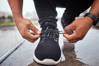 Buy stock photo Exercise, shoes and running with a sports man tying his laces for an outdoor cardio or endurance workout. Fitness, footwear and training with a male athlete or runner fastening his shoelaces outside
