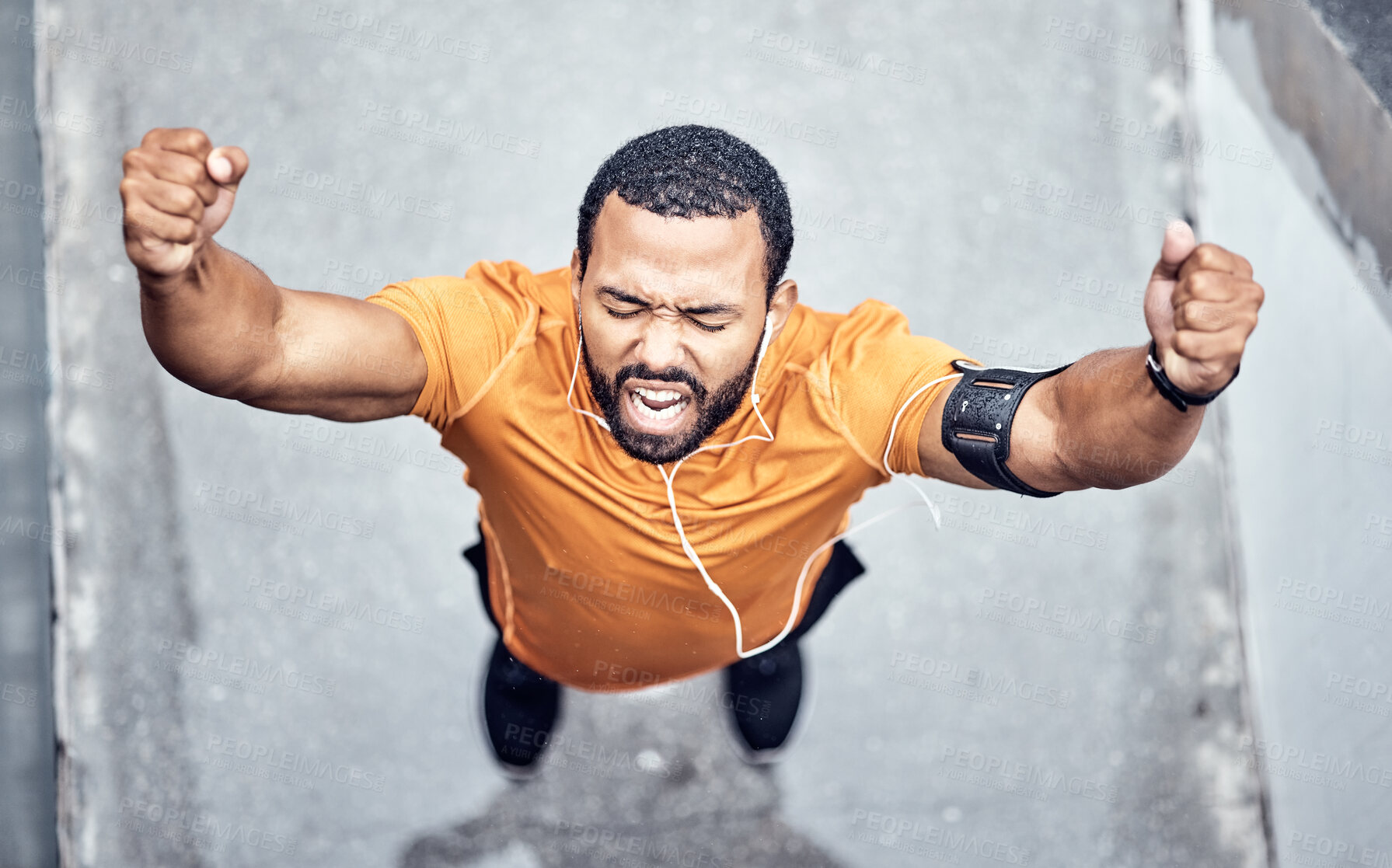 Buy stock photo Top view, black man and achievement for exercise, outdoor and celebration for target, happiness and fitness. African American male, runner or athlete with motivation, workout or training goal in city