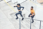 Fitness, above and running couple on stairs for training, health exercise and sports in city. Healthy, lifestyle and man and woman with focus, music and energy for outdoor cardio on steps in France