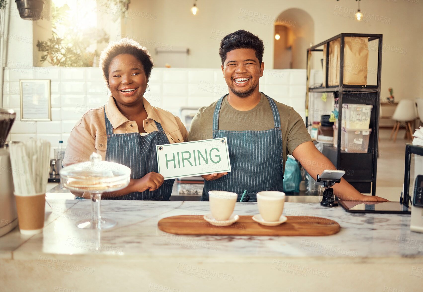 Buy stock photo Portrait, collaboration and hiring sign by small business owners happy at coffee shop or cafe in support together. Team, recruitment and friends due to startup growth due to vacancy, join us or job