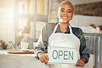 Showing, smile and portrait of a business owner with an open sign at a cafe in the morning. Restaurant, happy and woman with a board at a coffee shop with a welcome, smiling and server at a cafeteria