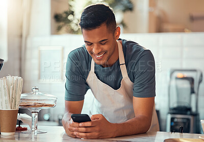 Buy stock photo Phone, small business and barista man in cafe shop for networking, online sales management and ecommerce. Happy waiter, cashier or worker person on smartphone, technology application in restaurant