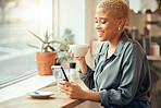 Coffee shop, phone and social media with a black woman customer drinking while typing a text message by a window. Internet cafe, mobile or communication with a female enjoying a drink in a restaurant