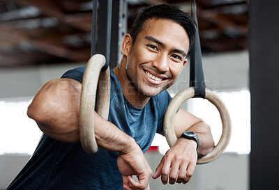 Buy stock photo Portrait, gymnastic rings and olympics with a man gymnast hanging on equipment for workout in gym. Face, fitness and exercise with a male athlete training in gymnastics for health or power