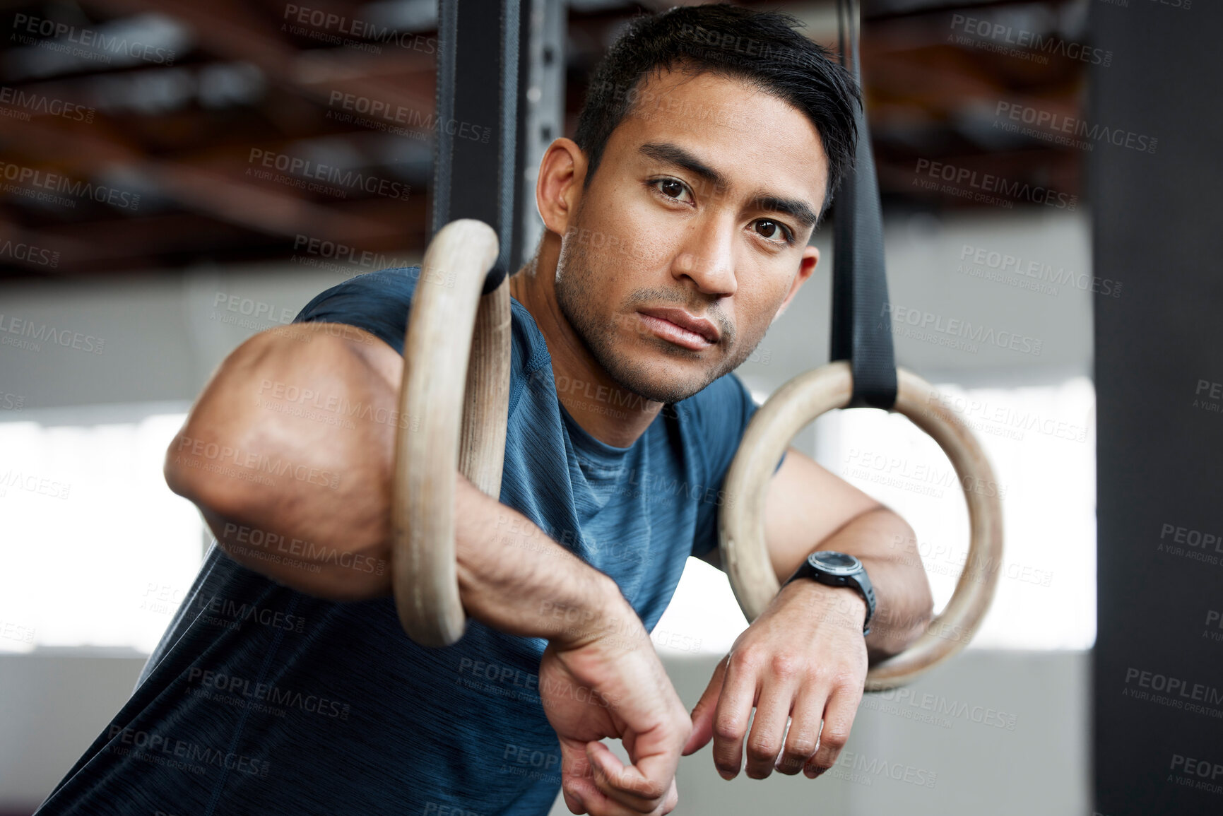 Buy stock photo Portrait, gymnastic rings and olympics with a man gymnast hanging on equipment for workout in gym. Face, fitness and exercise with a male athlete training in gymnastics for health or power