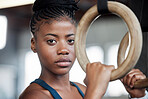 Fitness, gymnastics and portrait of a black woman with rings for training, muscle and arms at gym. Focus, strong and face of an African gymnast with performance during a workout or exercise at a club