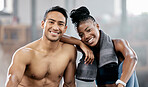 Portrait, fitness and diversity with a sports couple sitting in the gym together after a workout for health. Exercise, happy and strong with a man and woman athlete sitting in a training facility