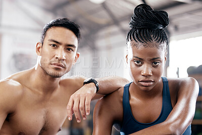 Buy stock photo Portrait, fitness and serious with a sports couple sitting in the gym together after a workout for health. Exercise, diversity and strong with a man and woman athlete sitting in a training facility