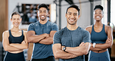 Fitness, portrait and man personal trainer with clients standing with crossed arms in the gym. Sports, collaboration and happy people after exercise, workout or training class in sport studio.