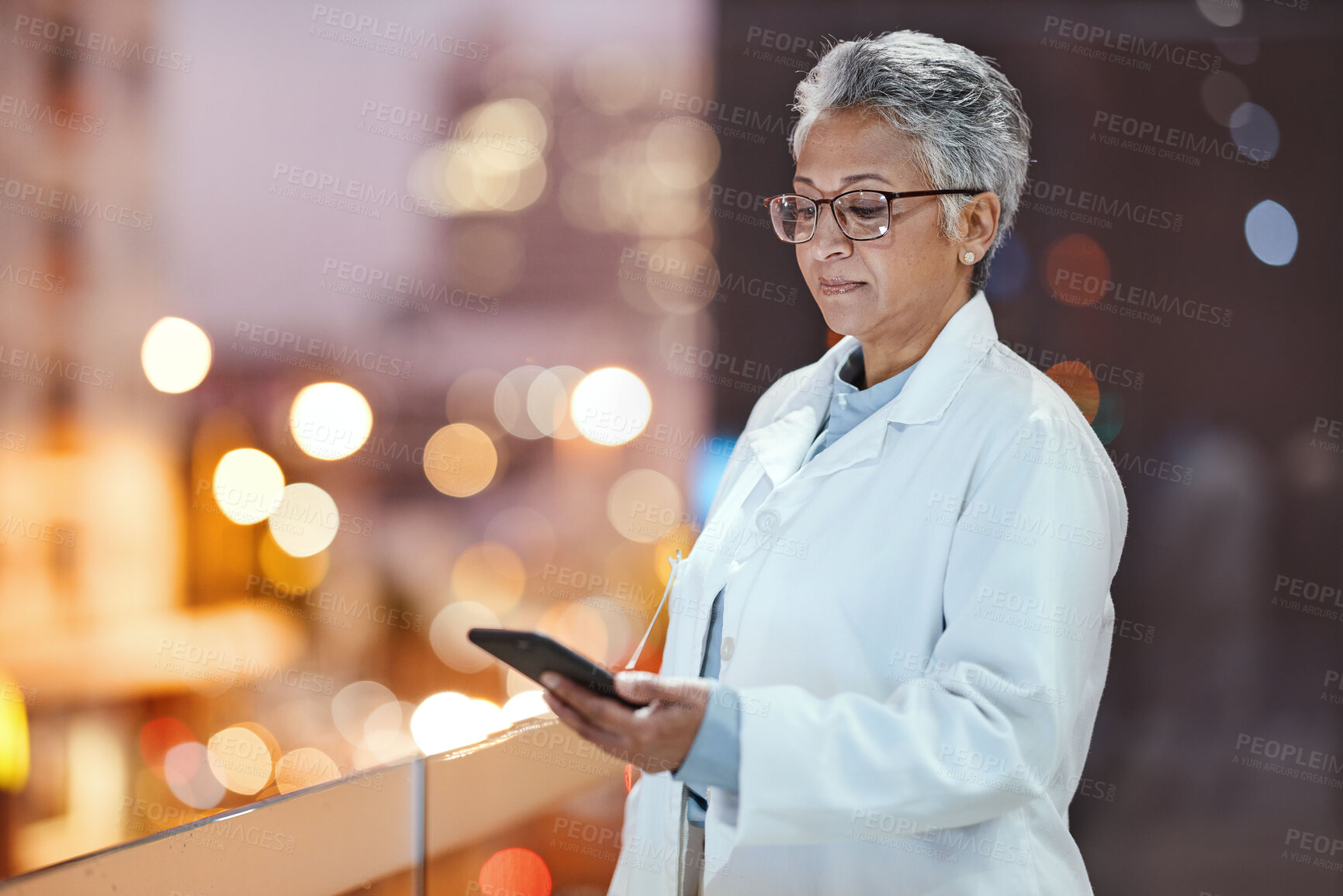 Buy stock photo Doctor, phone and senior woman on hospital rooftop for telehealth, research or online consultation in city. Bokeh, healthcare and female medical physician with smartphone for wellness app at night