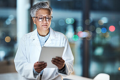 Buy stock photo Medical, research and night with doctor and tablet for planning, medicine and schedule. Technology, review and digital with senior woman reading report for healthcare, science and life insurance news