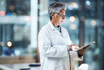 Buy stock photo Hospital, tablet and senior doctor working online for medical report, planning and research in clinic. Technology, healthcare and woman with digital tech for telehealth, insurance and consultation