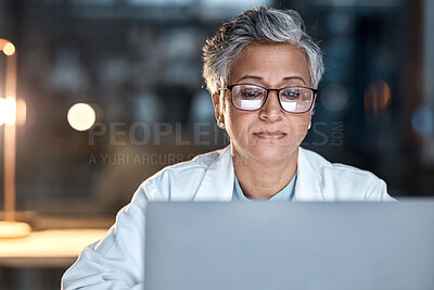 Buy stock photo Woman, doctor and laptop in office at night at workplace, hospital or desk for medical career vision. Healthcare expert, dark clinic or focus for reading at computer, email or cancer research article