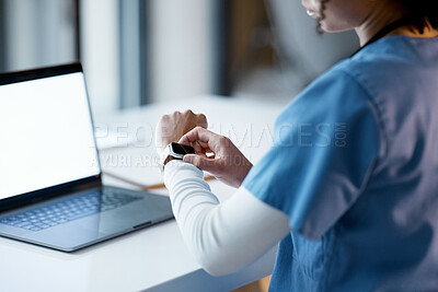 Buy stock photo Smartwatch, healthcare and time with a woman nurse working late at night on a laptop in the hospital. Medical, watch and overtime with a female medicine professional at work on a computer in a clinic