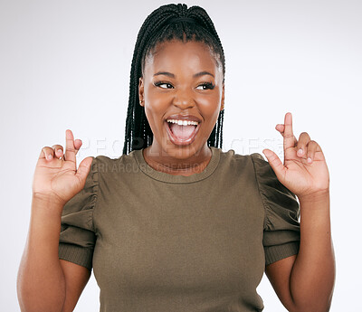 Buy stock photo Happy black woman, fingers crossed and good luck on studio background for competition, prize and lottery draw. Excited female hope for bonus, promotion and winning giveaway, smile and hand emoji sign