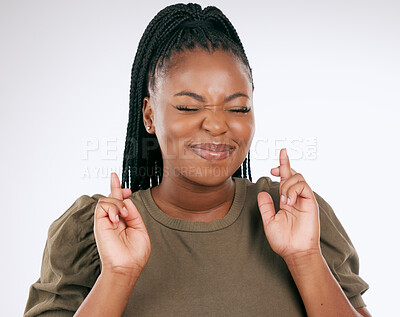 Buy stock photo Black woman, fingers crossed and luck for competition, prize or lottery draw against a grey studio background. African American female in hope for bonus, promotion or winning lucky giveaway on mockup
