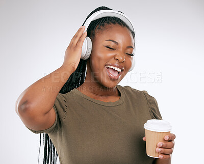 Buy stock photo Headphones, black woman and music listening with coffee of a happy young person in a studio. White background, isolated and happiness of a excited female hearing audio and singing to song alone