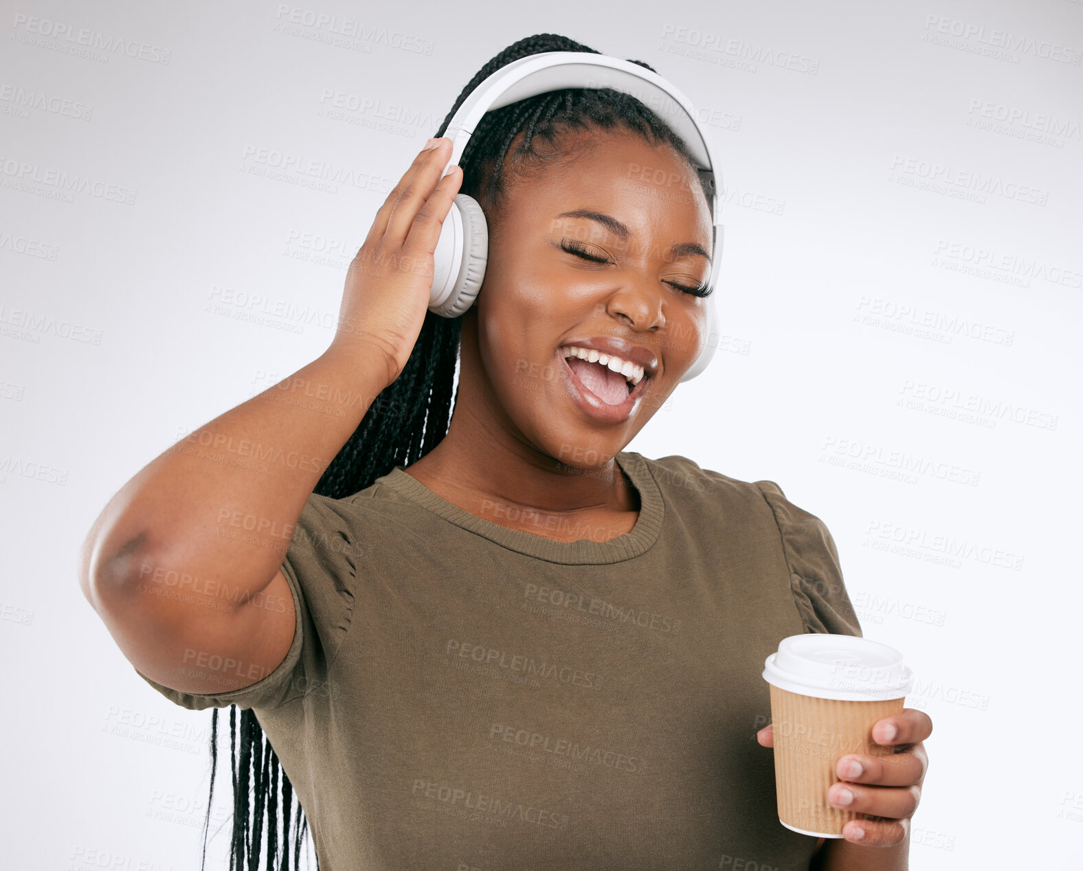 Buy stock photo Headphones, black woman and music listening with coffee of a happy young person in a studio. White background, isolated and happiness of a excited female hearing audio and singing to song alone