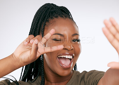Buy stock photo Happy black woman, peace sign and face for selfie, social media or profile picture against a grey studio background. Portrait of African American female wink with smile for joy showing hand gesture