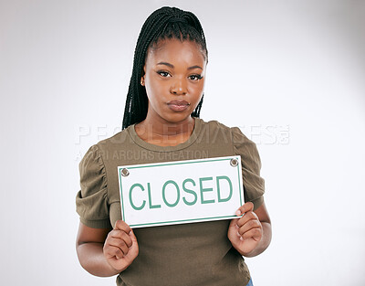 Buy stock photo Woman, holding closed sign and studio for small business, portrait or board for bankruptcy. African entrepreneur, poster and hands with serious face, company failure or financial crisis by background
