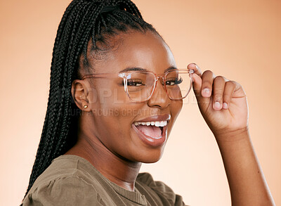 Buy stock photo Black woman, face and holding glasses for fashion, style or smart casual against a studio background. Portrait of happy African American female model smile for eyewear, spectacles and sight or vision