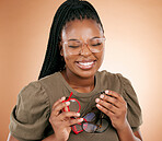 Happy, glasses frame choice and black woman with a smile from eye care and retail product. Studio background, isolated and beauty of a young student feeling happiness and excited about shopping
