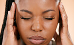 Black woman, face and closed eyes with headache, pain or suffering from stress against a studio background. Closeup of African American female holding head or painful area in mental health problems