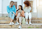 Student, friends and tablet on stairs in conversation, social media or communication at campus. Happy women enjoying discussion, chat or talking with touchscreen together on staircase at university