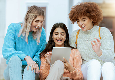 Buy stock photo Student, friends and tablet laughing for entertainment streaming, social media or communication at campus. Happy women enjoying funny meme, laugh or browsing online research on touchscreen together