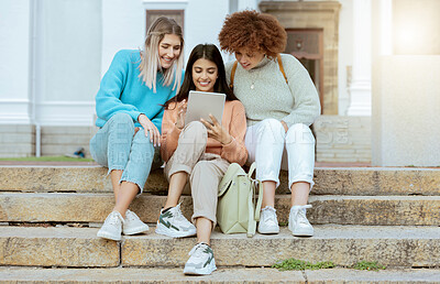 Buy stock photo Student, friends and tablet on stairs in social media, communication or streaming entertainment at campus. Happy women enjoying online research, chat or browsing on touchscreen together on staircase